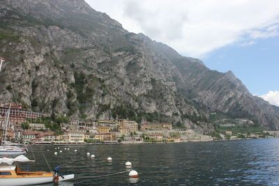 Sailboats in lake against mountain range