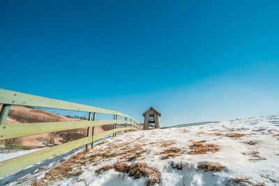 Scenic view of snowcapped mountains against clear blue sky