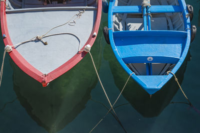 Close-up of colorful umbrellas in front of harbor