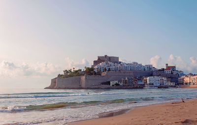 Buildings on beach against sky