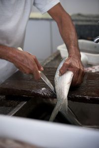 Midsection of man preparing food