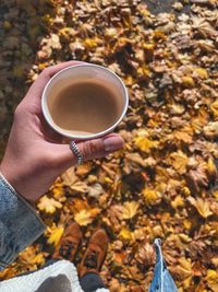 Midsection of person holding coffee cup