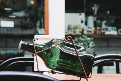 Close-up of leaf in glass container on table