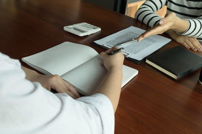 High angle view of woman using mobile phone on table