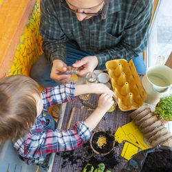 High angle view of boy playing on table