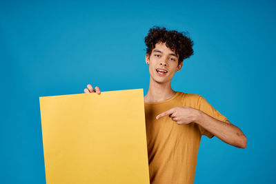 Woman standing against blue background