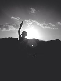 Silhouette of woman at sunset