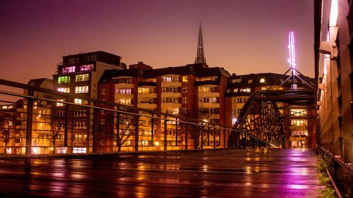 View of illuminated bridge over river at night