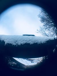 Close-up of snow covered landscape against sky