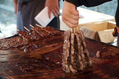 Close-up of man preparing food on table