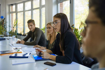 Students sitting at table at university