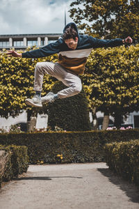 Full length of young man against plants