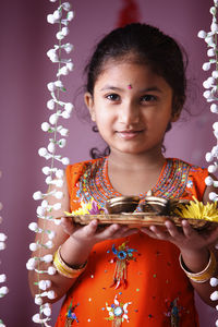 Portrait of girl holding plate