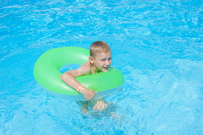 High angle view of boy swimming in pool