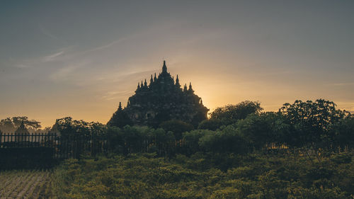 Temple building against sky during sunset