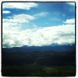 Scenic view of mountains against cloudy sky