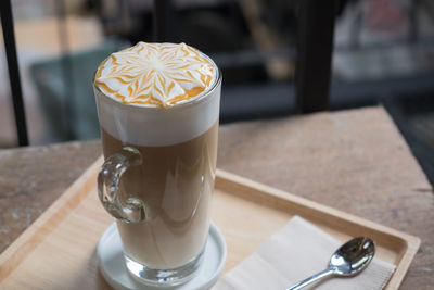 Close-up of cappuccino served on table