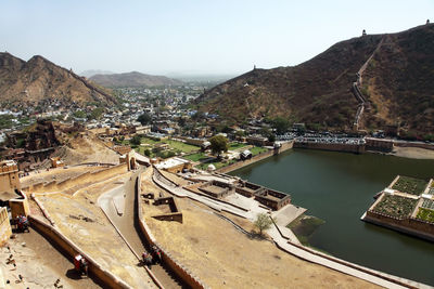High angle view of amer fort by mountains and residential district