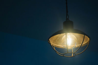 Close-up of illuminated lamp against black background