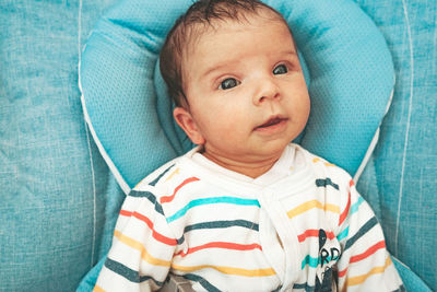 Portrait of cute baby lying on bed