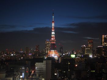 Illuminated cityscape against sky at night