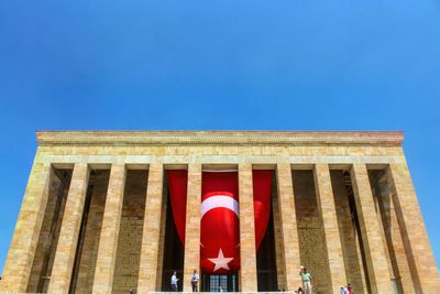 Low angle view of building against clear blue sky