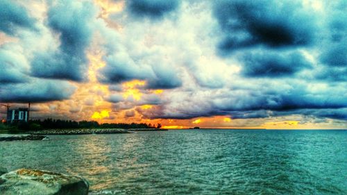 Scenic view of sea against cloudy sky