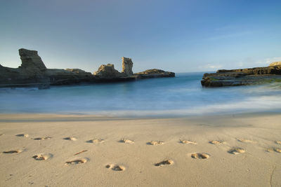 View of beach against clear blue sky