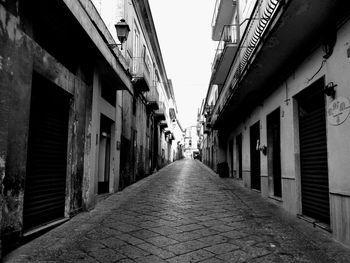 Street amidst buildings against sky