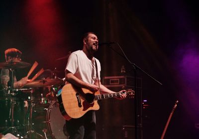 Man playing guitar at music concert