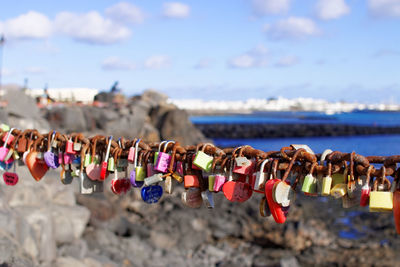 Close-up of padlocks on railing against river