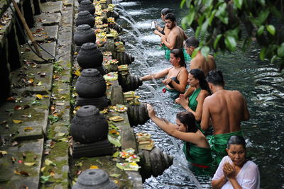 People waiting for bath in fountain at temple