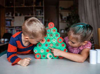 Kid making handmade advent calendar with toilet paper rolls. seasonal activity, family holidays