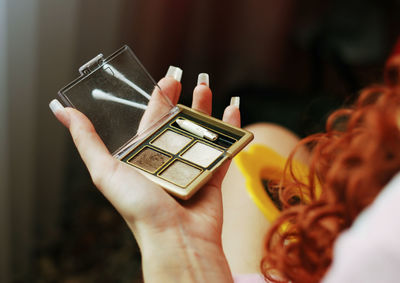 Eye shadow on the palm of a woman doing her makeup