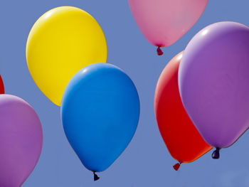 Low angle view of balloons against sky