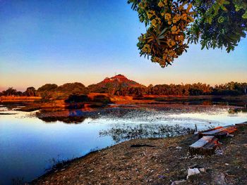 Scenic view of lake against clear blue sky