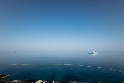 Scenic view of sea against clear blue sky