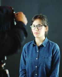 Woman posing for photographer at studio