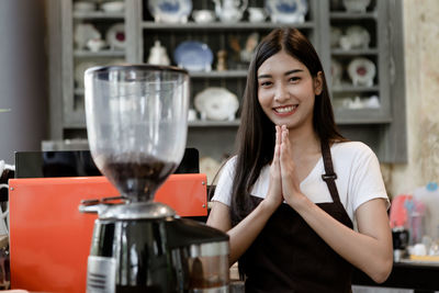 Portrait of a smiling young woman with drink