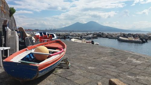 Boats moored on sea against sky