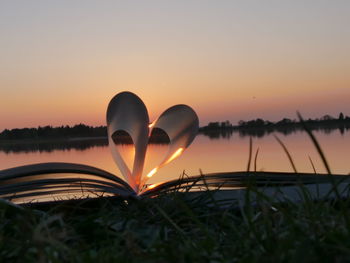 Close-up of heart shape against sky during sunset