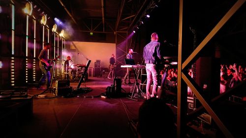 Group of people at illuminated stage