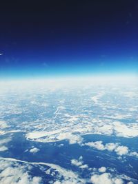 Aerial view of clouds over landscape against blue sky