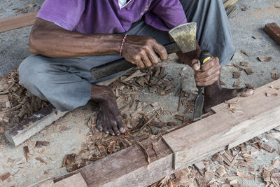 Low section of carpenter with wood working outdoors