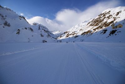 Scenic view of snow covered mountains against sky