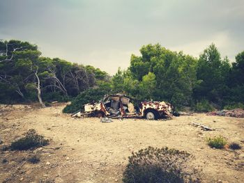 Abandoned built structure on landscape against sky