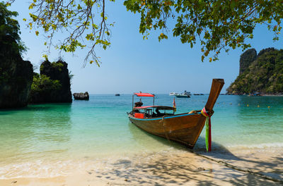 Landscape of long tail boat riding on the blue sea of lagoon of koh hong, krabi, thailand in summer