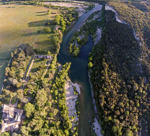 High angle view of river amidst trees in city