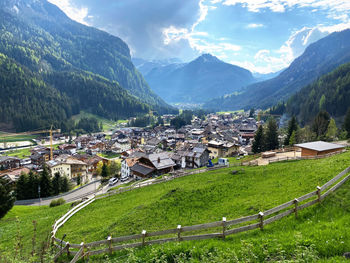 Aerial view of townscape and mountains against sky