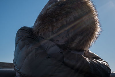 Full length of senior woman against clear sky during winter